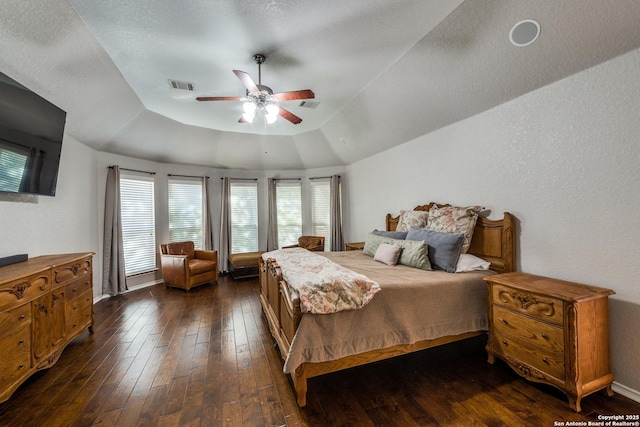 bedroom featuring dark wood-type flooring, ceiling fan, lofted ceiling, and a textured ceiling