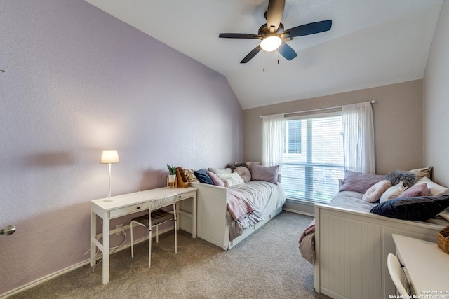 bedroom with vaulted ceiling, light colored carpet, and ceiling fan