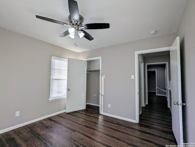 unfurnished bedroom featuring ceiling fan, dark wood-type flooring, and a closet