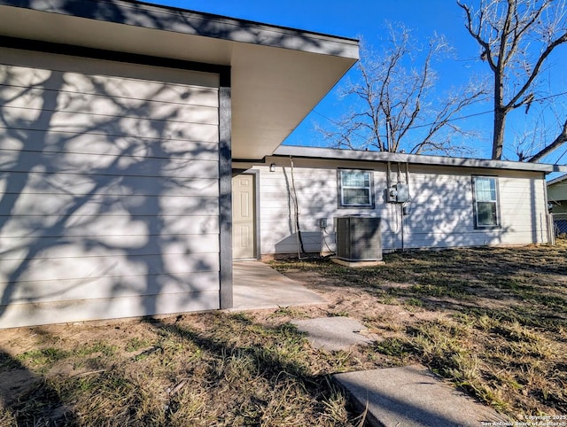 view of property exterior featuring central AC and a patio