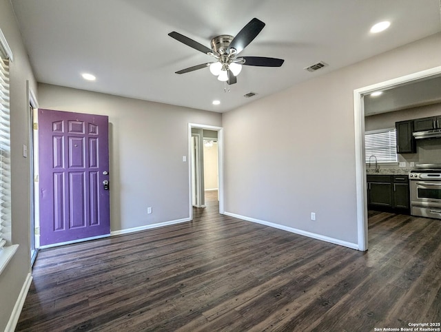 interior space featuring ceiling fan, dark hardwood / wood-style flooring, and sink