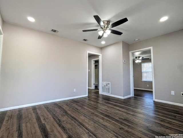 spare room with dark wood-type flooring and ceiling fan