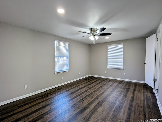 empty room featuring ceiling fan and dark wood-type flooring