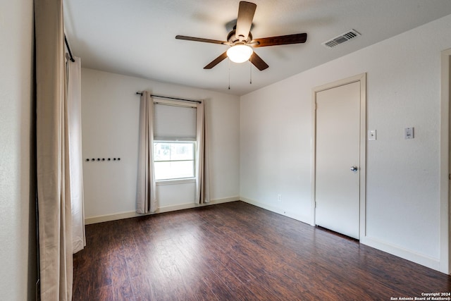 unfurnished room featuring ceiling fan and dark hardwood / wood-style flooring