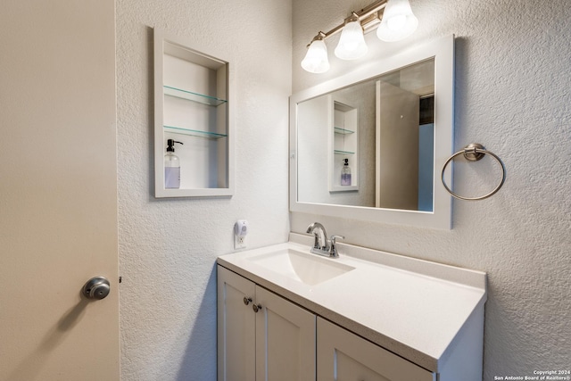 bathroom featuring built in shelves and vanity