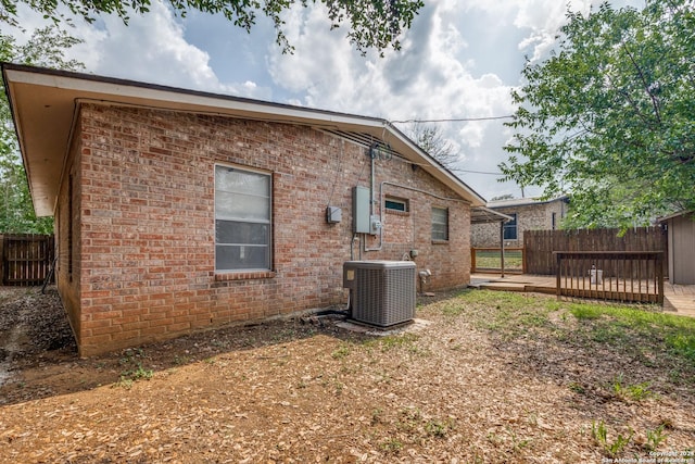 back of property featuring a wooden deck and central air condition unit