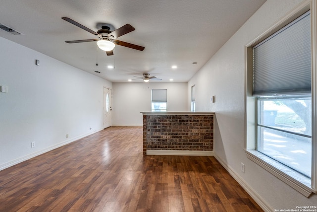 spare room with ceiling fan and dark wood-type flooring