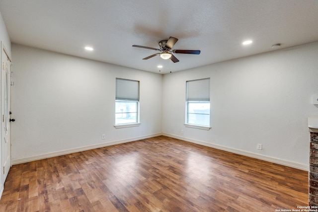 unfurnished room featuring ceiling fan, a textured ceiling, and hardwood / wood-style flooring