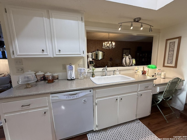 kitchen featuring pendant lighting, white cabinets, sink, dark hardwood / wood-style floors, and white dishwasher