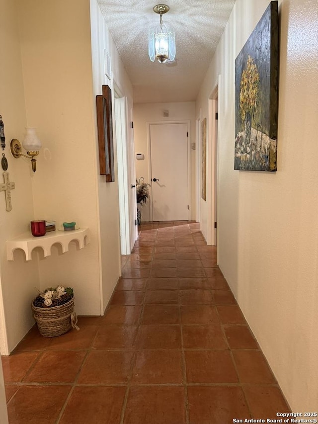 hall with a textured ceiling