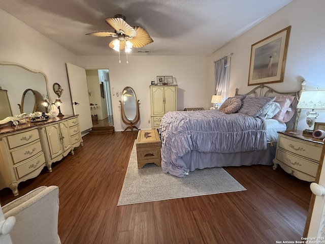 bedroom featuring ceiling fan and dark hardwood / wood-style floors