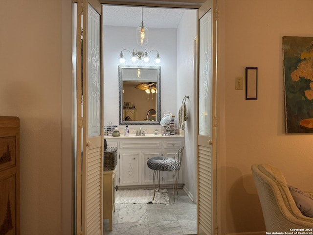 bathroom with a textured ceiling and vanity