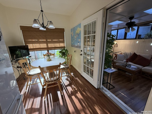 sunroom with ceiling fan with notable chandelier