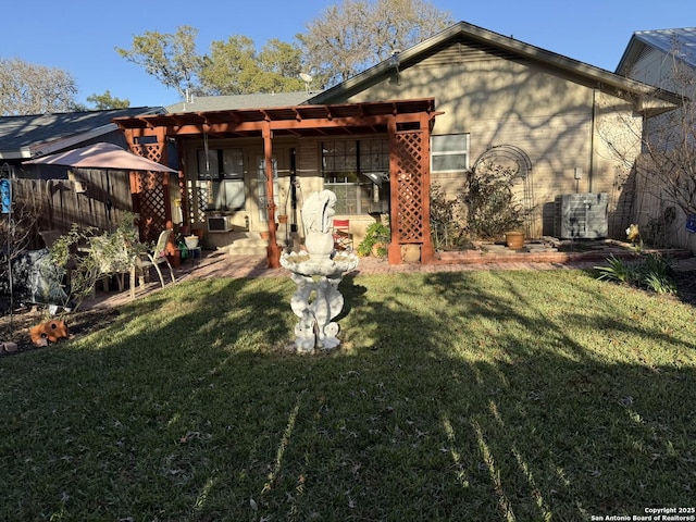 rear view of house featuring a lawn