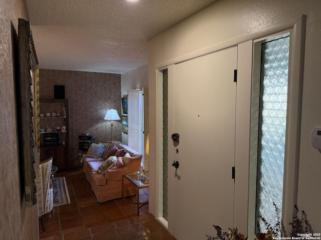 tiled entrance foyer with a textured ceiling