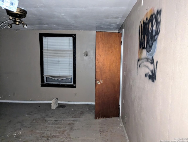 unfurnished room with concrete floors