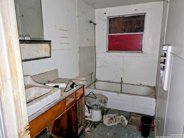 bathroom featuring toilet, vanity, and a bathing tub