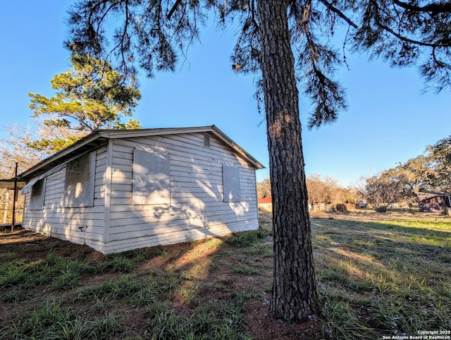 view of property exterior with a lawn