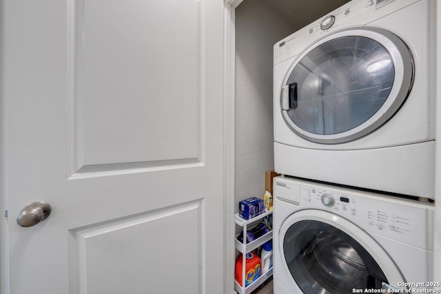 laundry area featuring stacked washer / drying machine