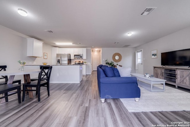 living room with light hardwood / wood-style floors