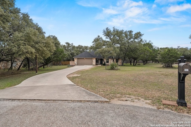 view of front of house featuring a front yard and a garage