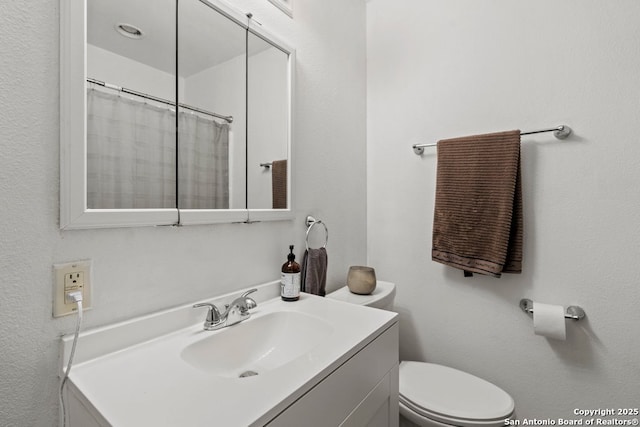 bathroom with toilet and vanity