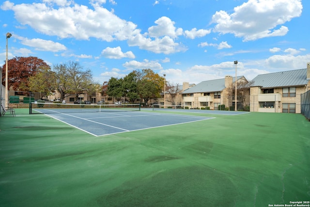 view of tennis court featuring basketball court