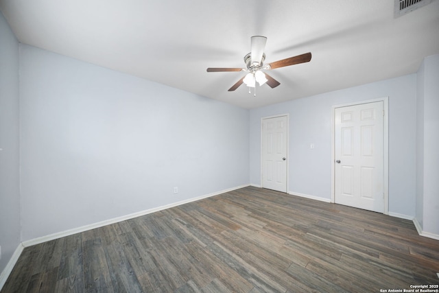 empty room featuring ceiling fan and dark hardwood / wood-style floors