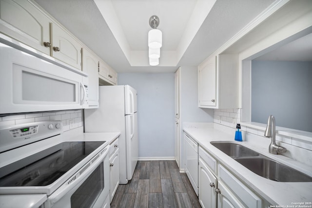 kitchen with white cabinets, sink, and white appliances