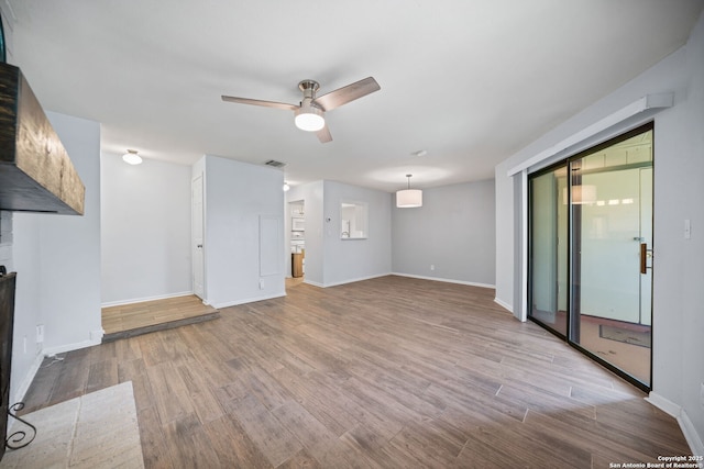 unfurnished living room featuring ceiling fan and light hardwood / wood-style floors