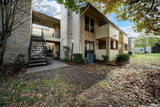 back of house featuring central air condition unit