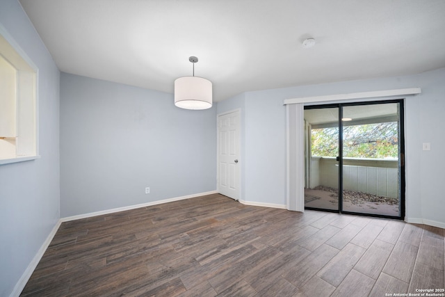 spare room with dark wood-type flooring