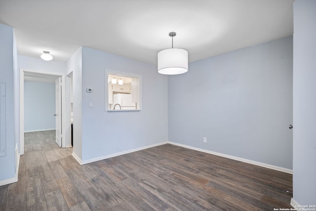 spare room featuring dark hardwood / wood-style flooring