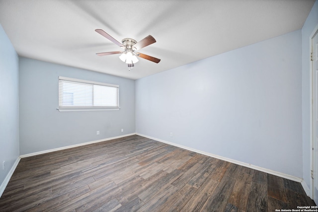 empty room with ceiling fan and dark hardwood / wood-style floors