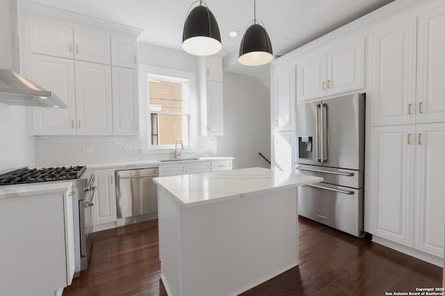 kitchen featuring a kitchen island, sink, white cabinets, wall chimney exhaust hood, and high quality appliances