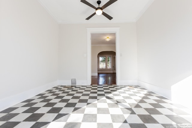 spare room featuring ceiling fan and ornamental molding