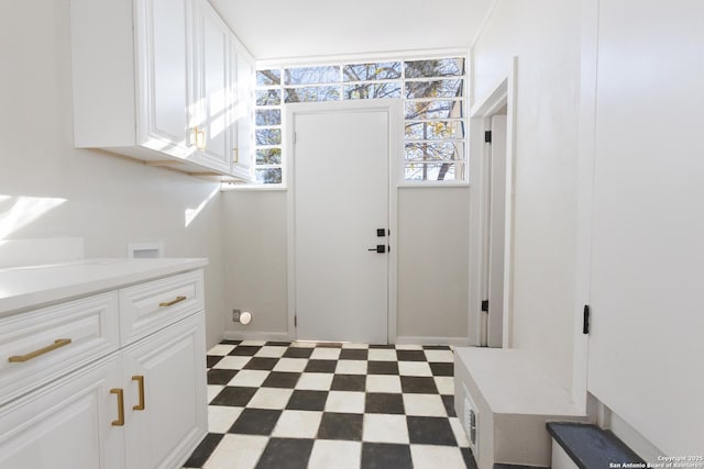 laundry room featuring cabinets