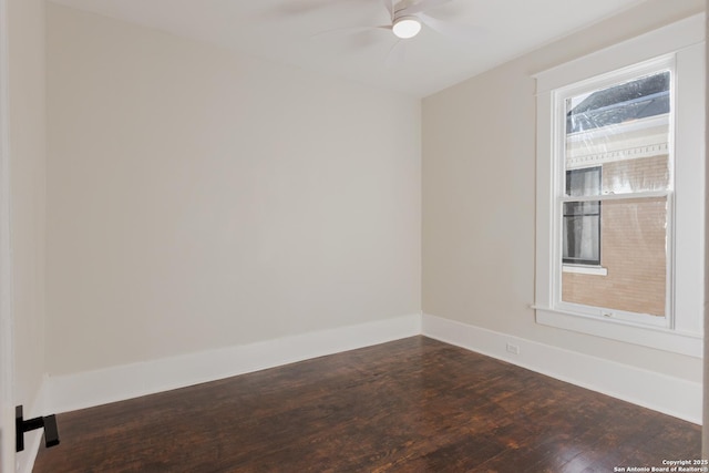 spare room with dark wood-type flooring and ceiling fan