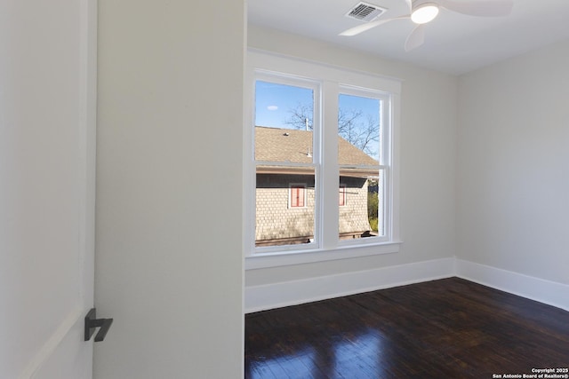 unfurnished room with ceiling fan and dark wood-type flooring