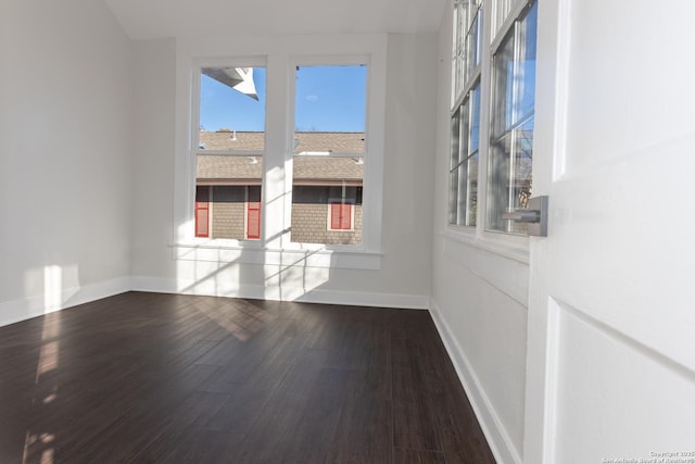 unfurnished room with wood-type flooring