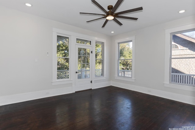 spare room with ceiling fan and dark hardwood / wood-style floors