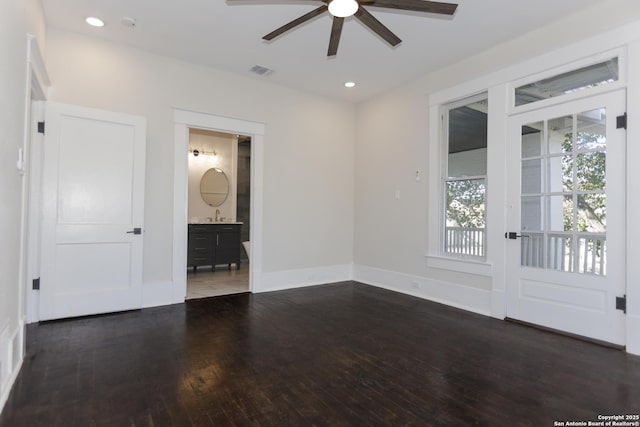 empty room with dark wood-type flooring and ceiling fan