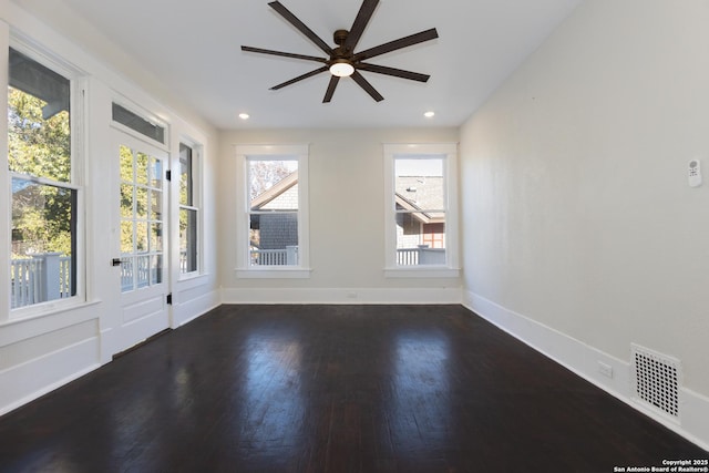 empty room with dark wood-type flooring and ceiling fan