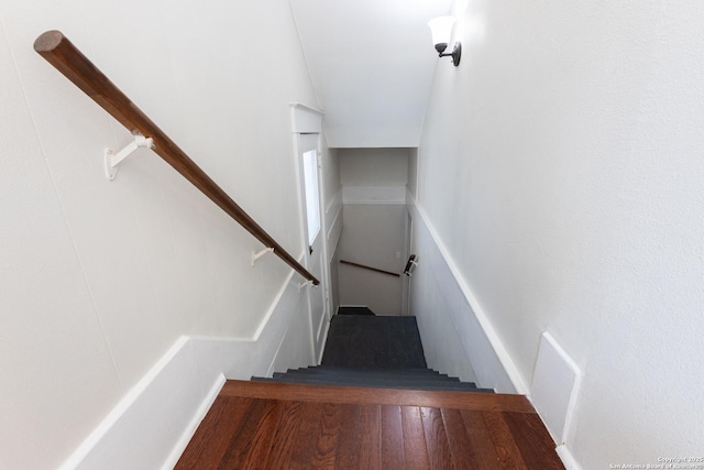 staircase with hardwood / wood-style floors