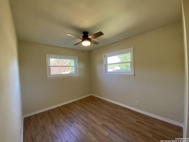 unfurnished room featuring ceiling fan and dark hardwood / wood-style flooring