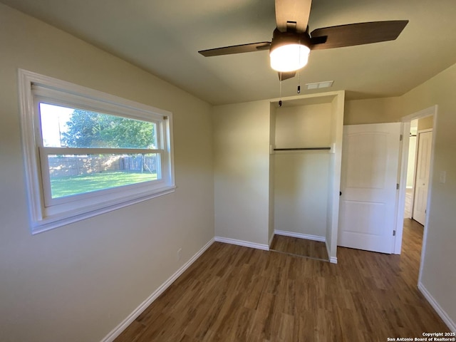 unfurnished bedroom with dark wood-type flooring and ceiling fan