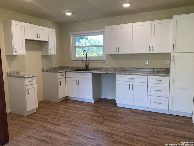 kitchen featuring dark hardwood / wood-style floors, white cabinets, and sink