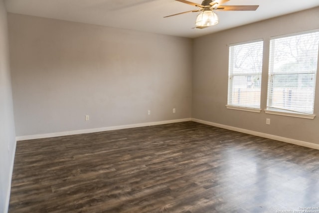 empty room featuring ceiling fan and dark hardwood / wood-style floors