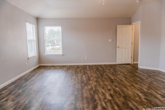 unfurnished room with dark wood-type flooring