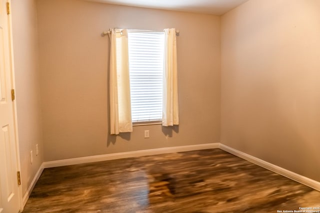 spare room featuring dark hardwood / wood-style floors